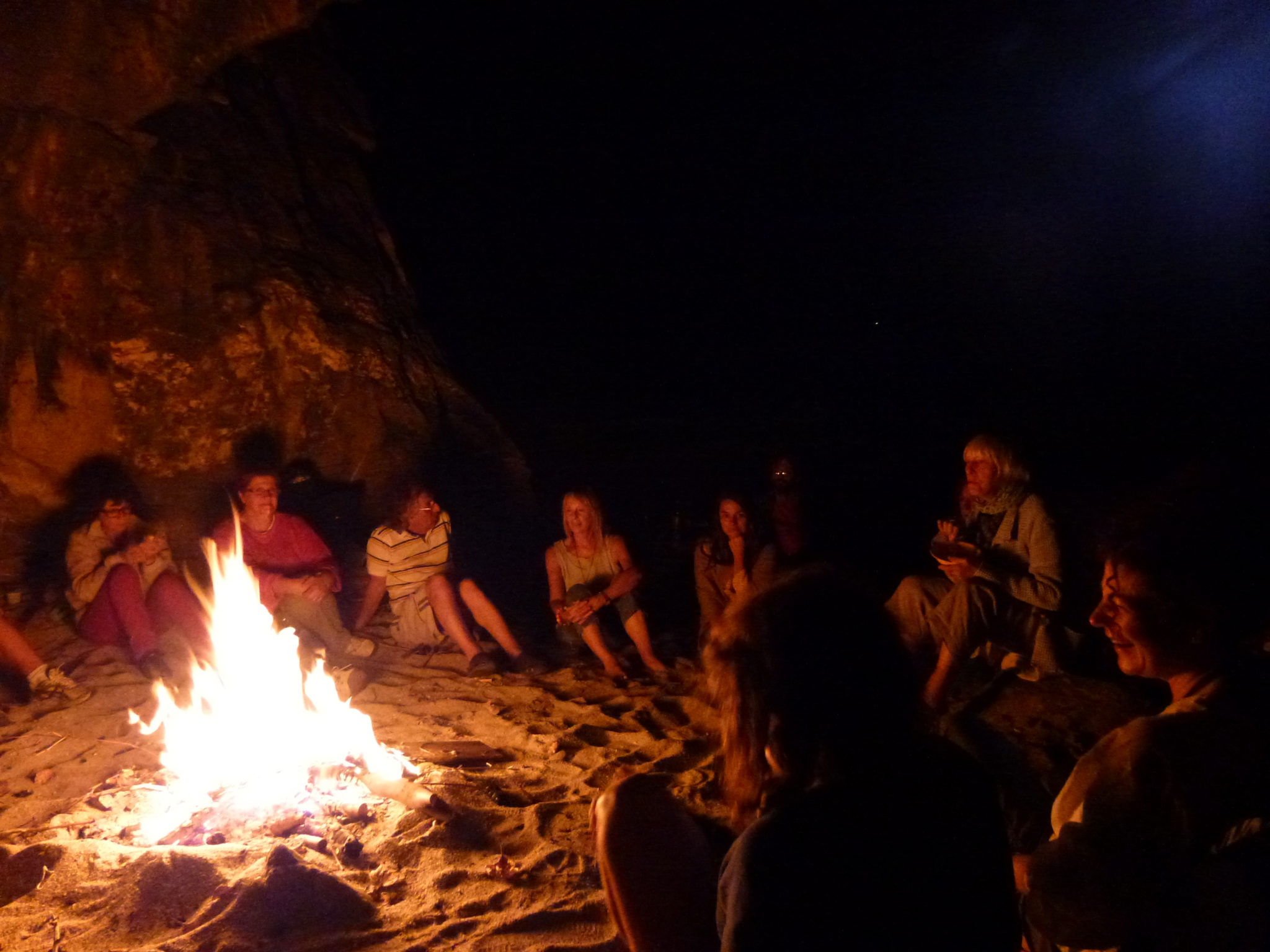 walkers have a campfire on the beach